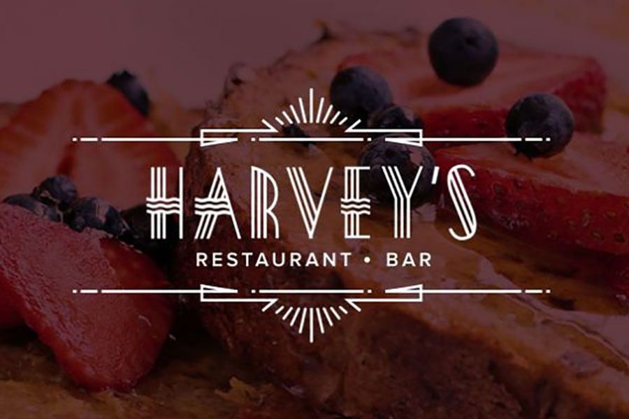 Harvey's Restaurant and Bar logo on top of photo of food